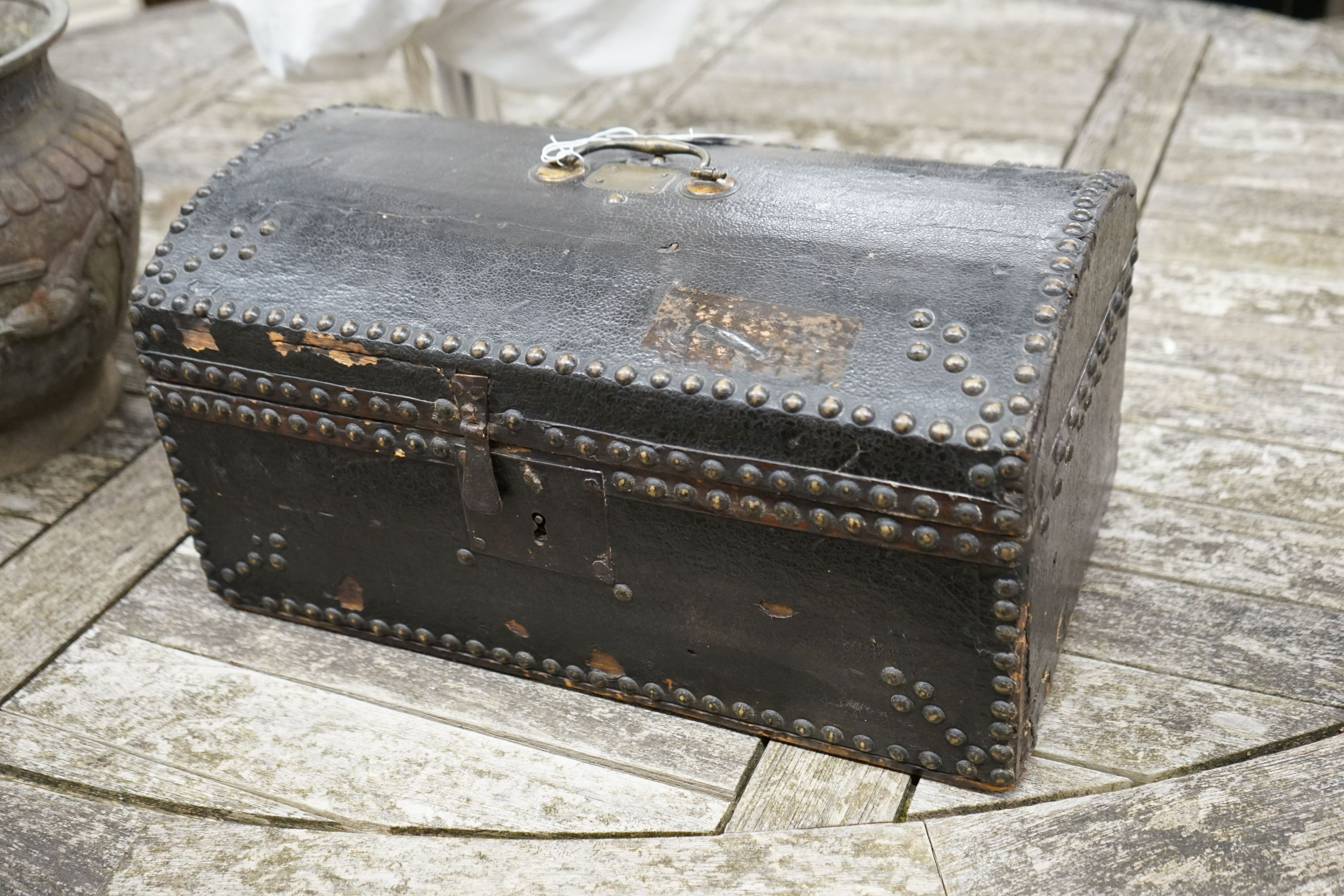 An early 19th century small domed topped leather trunk, bears interior label John Shepherd, Trunk Maker and Undertaker, London, width 45cm, depth 26cm, height 23cm